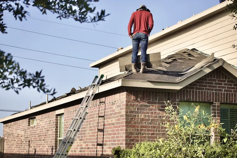 Professional roofer working on a residential roof in Franklin Manor Beach